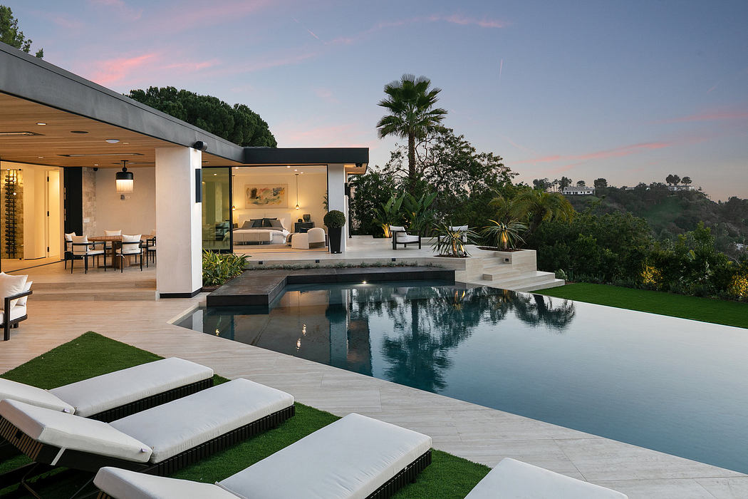 Modern house with open living space and infinity pool overlooking scenic vista.