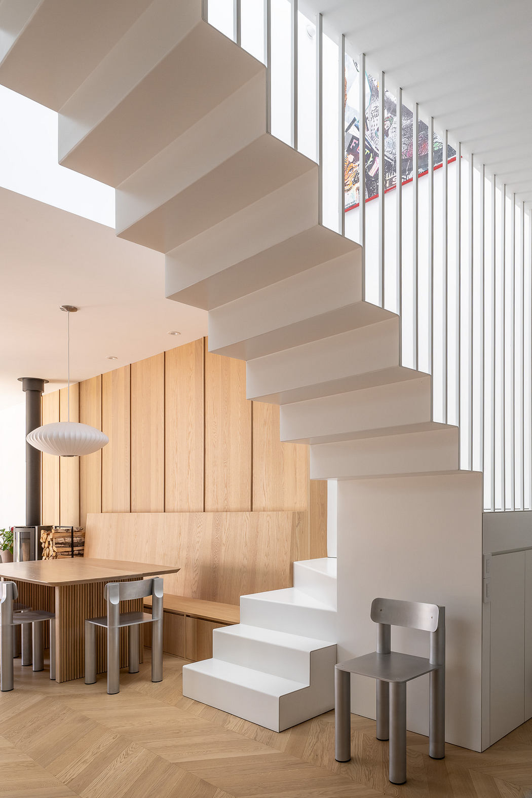 Modern interior with floating white staircase and wooden accents.