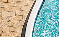 Beautiful view of stone tiles and swimming pool.