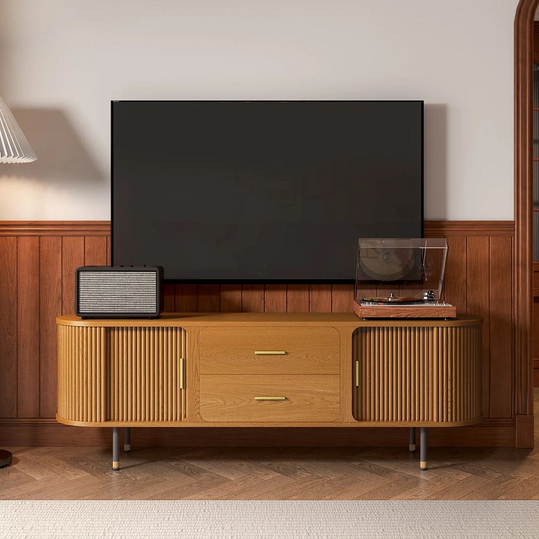 Vintage-inspired TV console with accessories against a wooden wall.