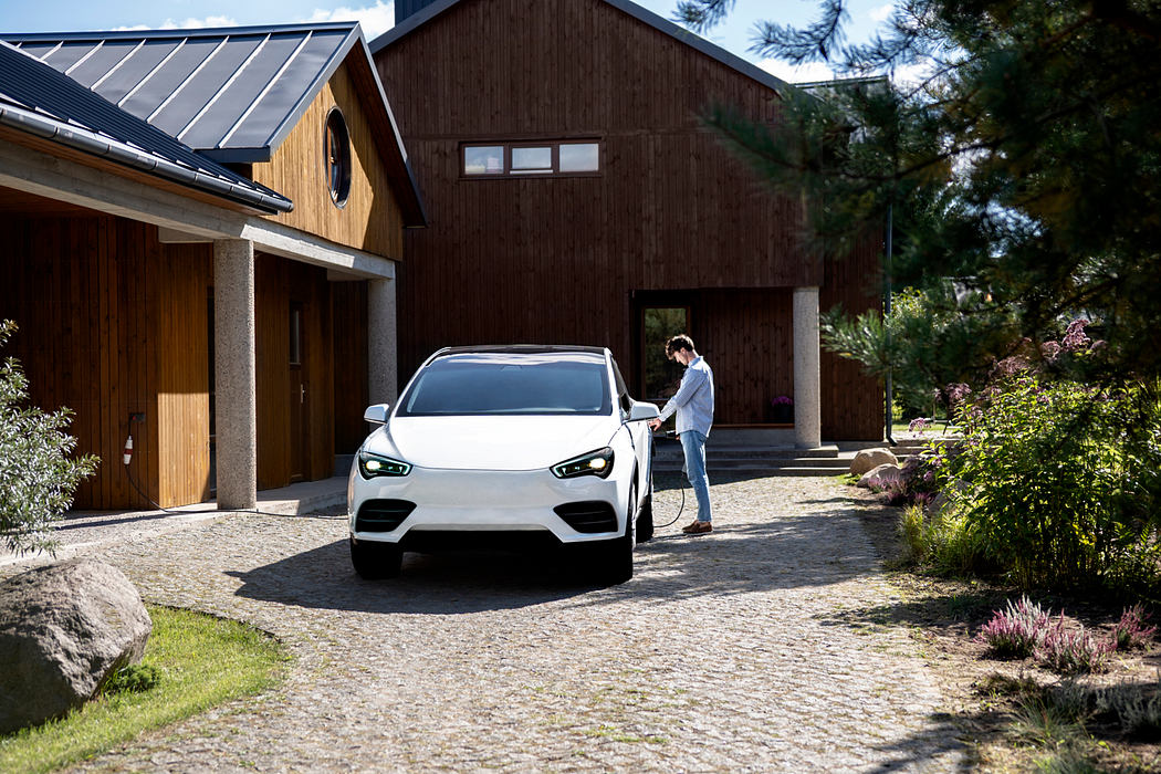 Modern home exterior with wooden architecture and a white car in the driveway.