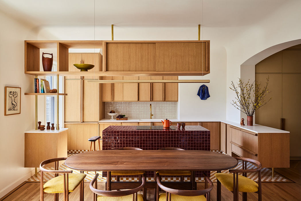 Modern kitchen with wooden cabinetry, round table, and yellow stools.
