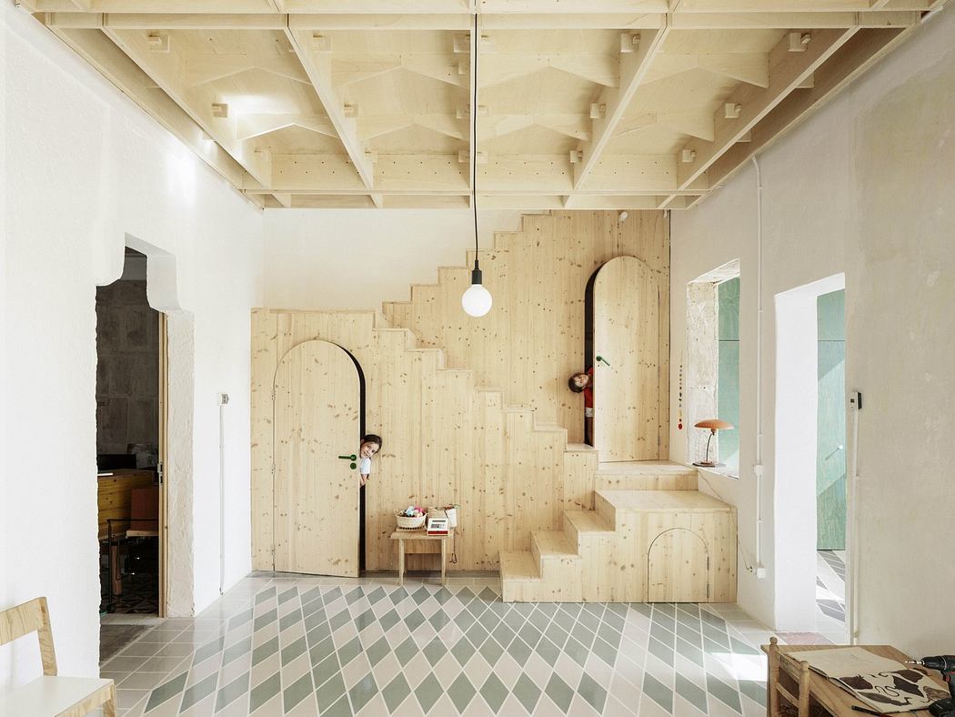 Minimalist room with plywood staircase and patterned tile floor.
