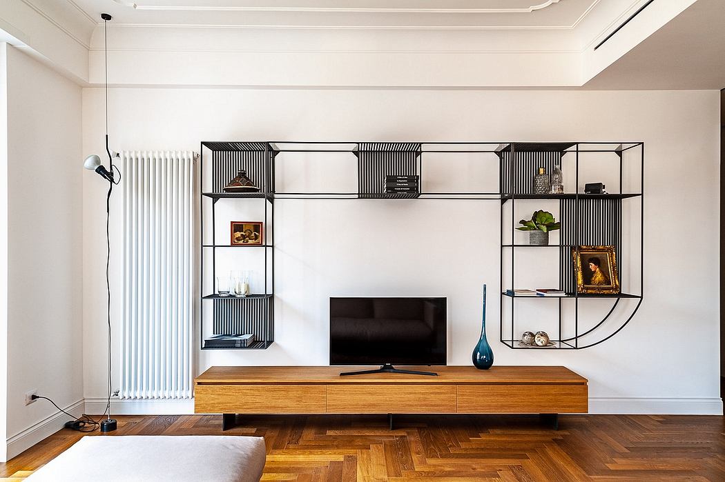 Minimalist living room with sleek shelving unit and wooden floor.