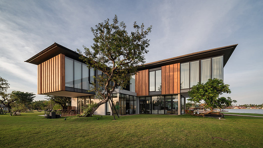 Contemporary house with large glass windows and wooden slats.