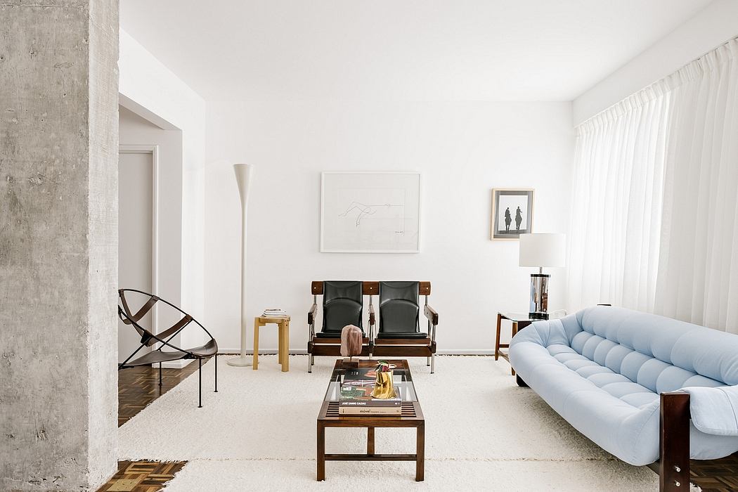 Minimalist living room with white walls, modern furniture, and large window.