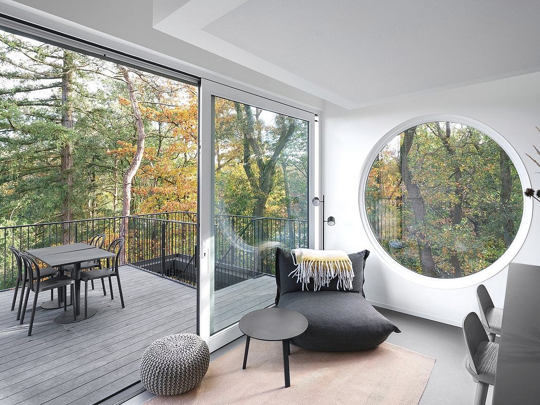 Minimalist interior with large windows and a circular porthole, opening to a