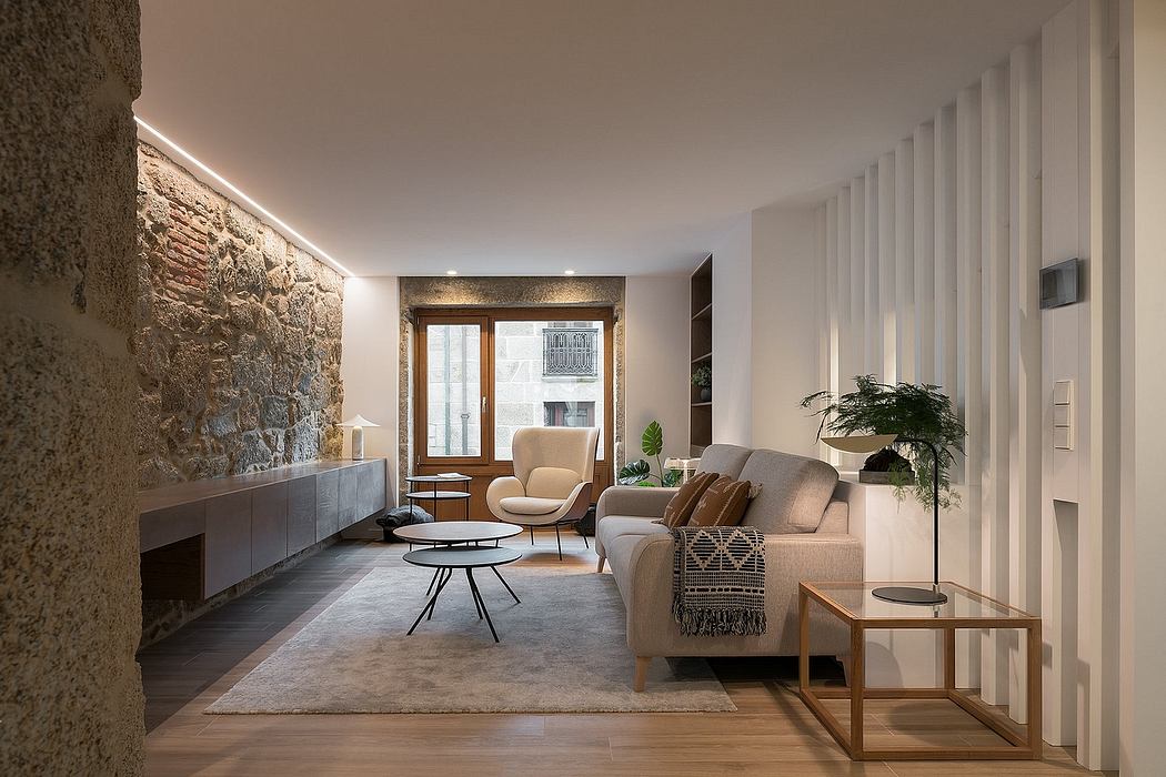 Contemporary living room with exposed stone wall and sleek furnishings.