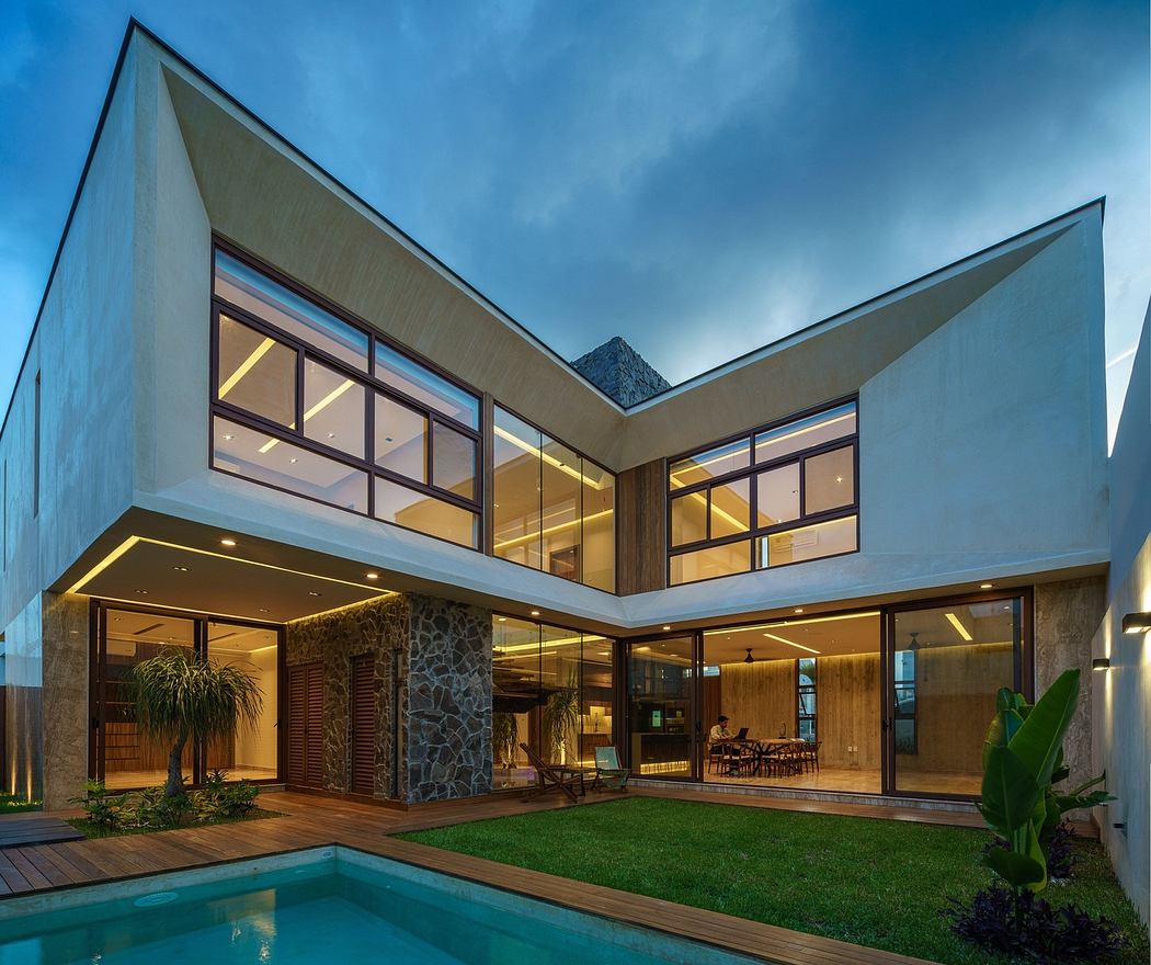 Angular contemporary house with pool at dusk