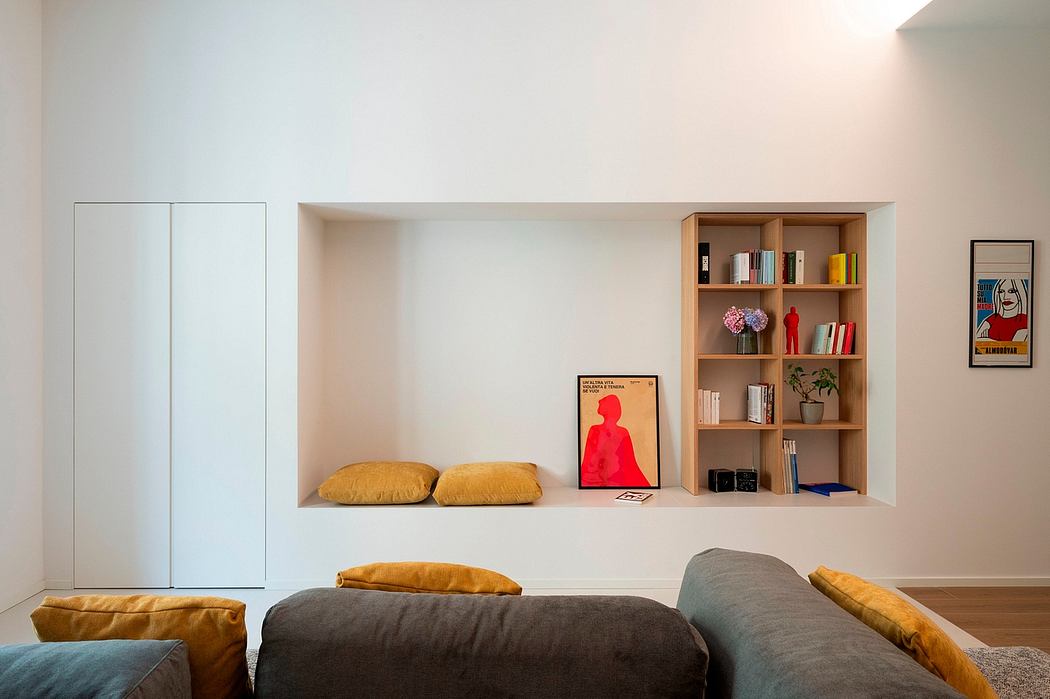 Modern living room with built-in shelving, comfortable seating and wall art.