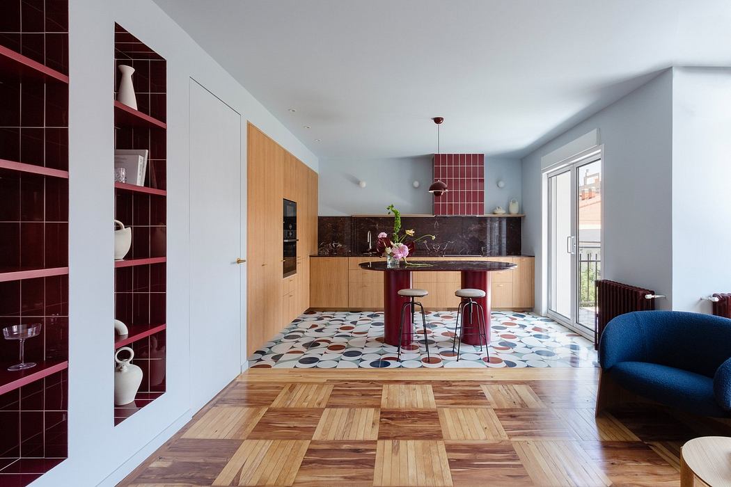 Modern kitchen with patterned floor, wooden cabinetry, and burgundy accents.