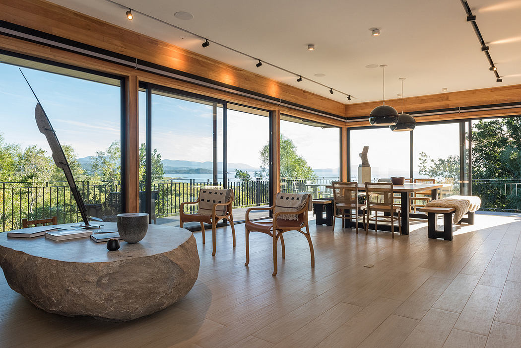 Spacious room with large windows, wooden floors, and minimalist decor.