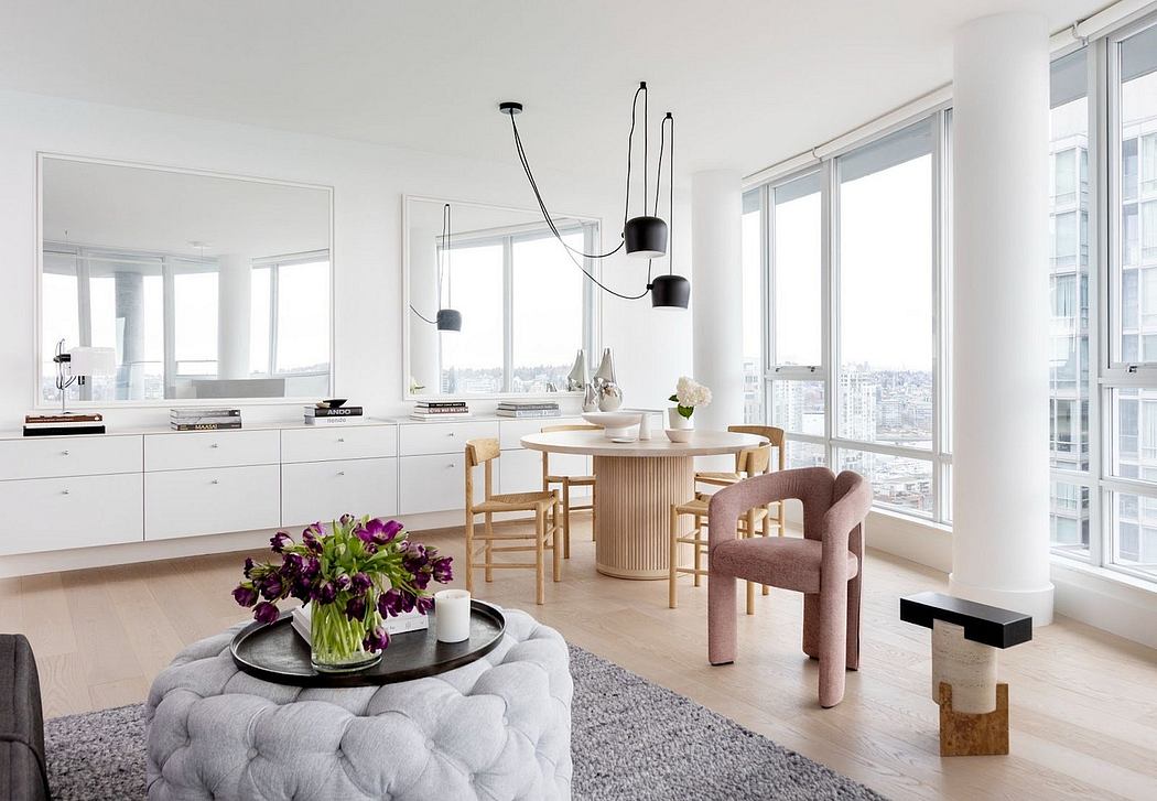 Bright, minimalist apartment interior with sleek kitchen and large windows.