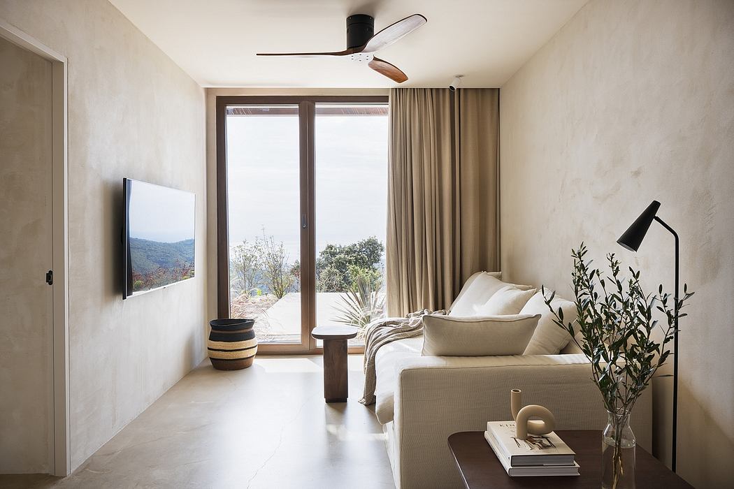 Contemporary living room with neutral tones, minimal decor, and large window.