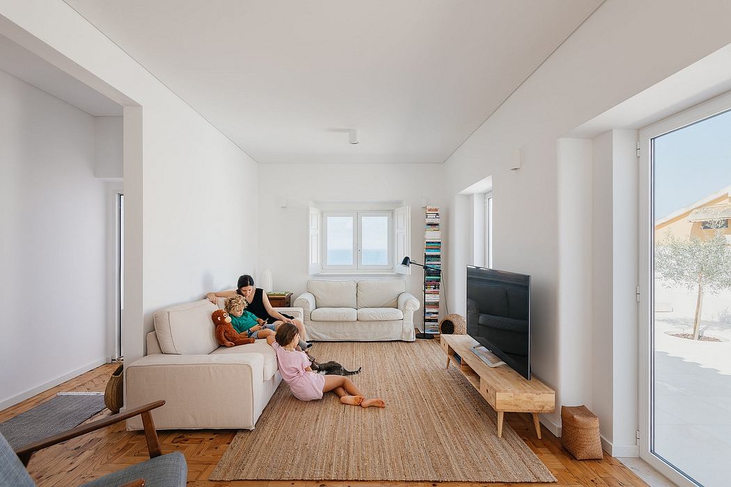 Minimalist living room with two children playing and natural light.