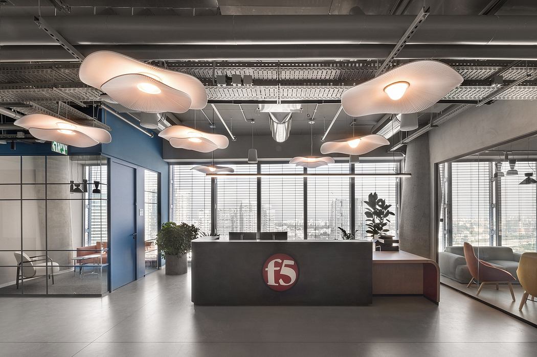Contemporary office lobby with unique cloud-shaped lights and minimalist decor.