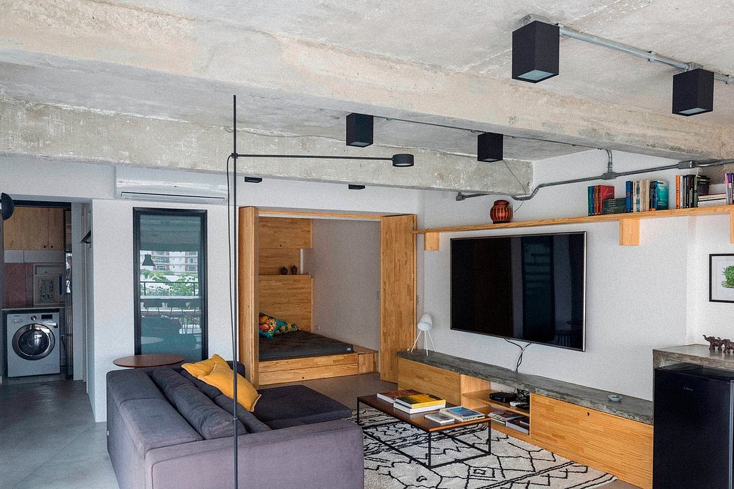 Contemporary studio apartment with exposed ceiling and wood accents.