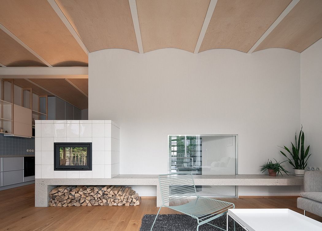 Modern living room with fireplace, wood storage, and scalloped ceiling.