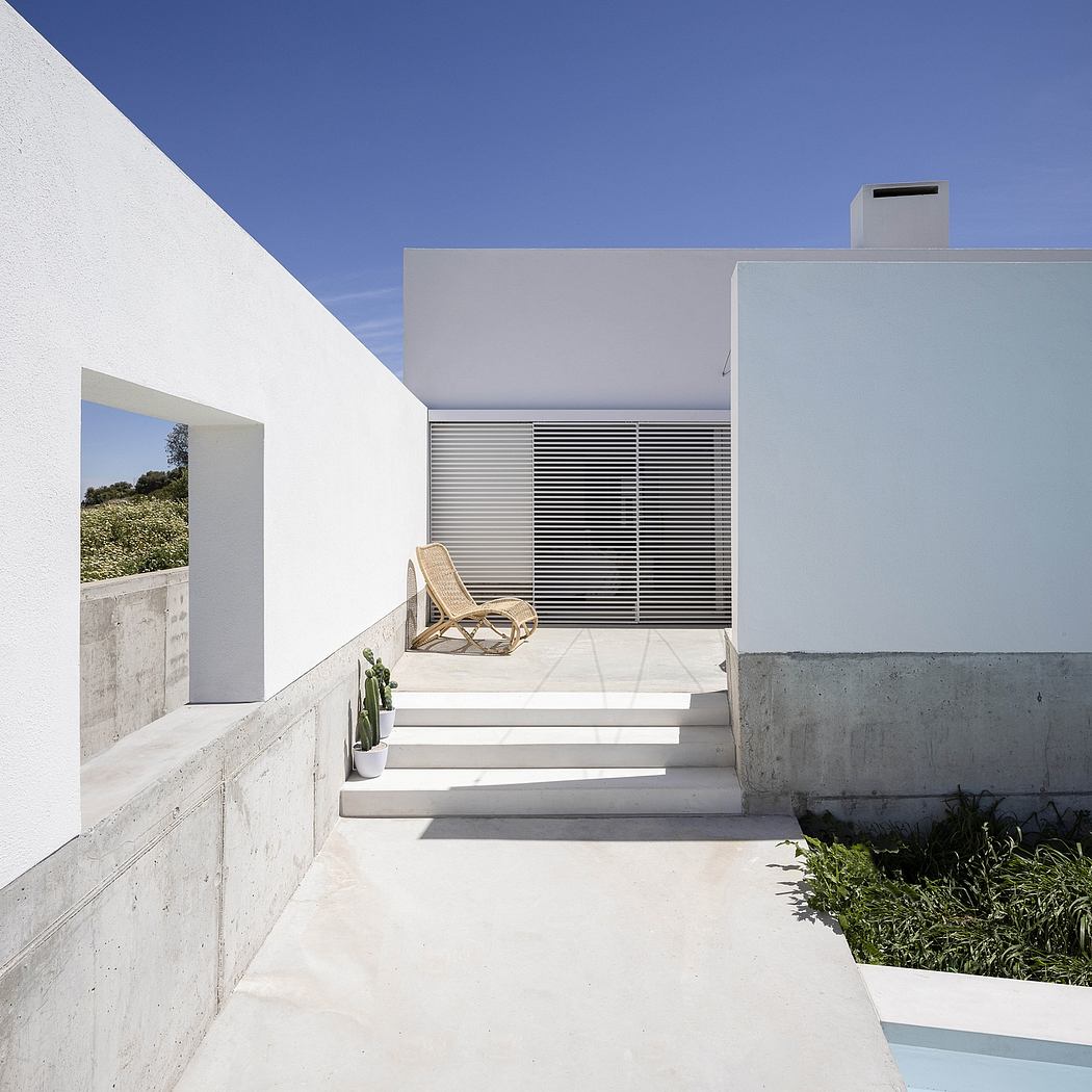 Contemporary white house with clean lines and a pool.