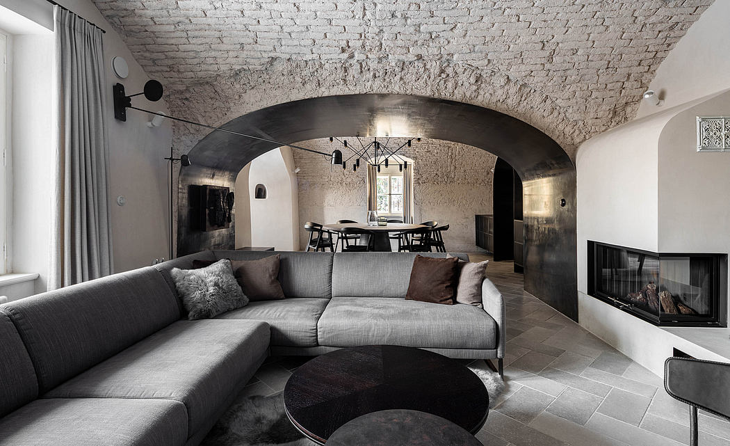 Modern living room with arched brick ceiling, sectional sofa, and fireplace.