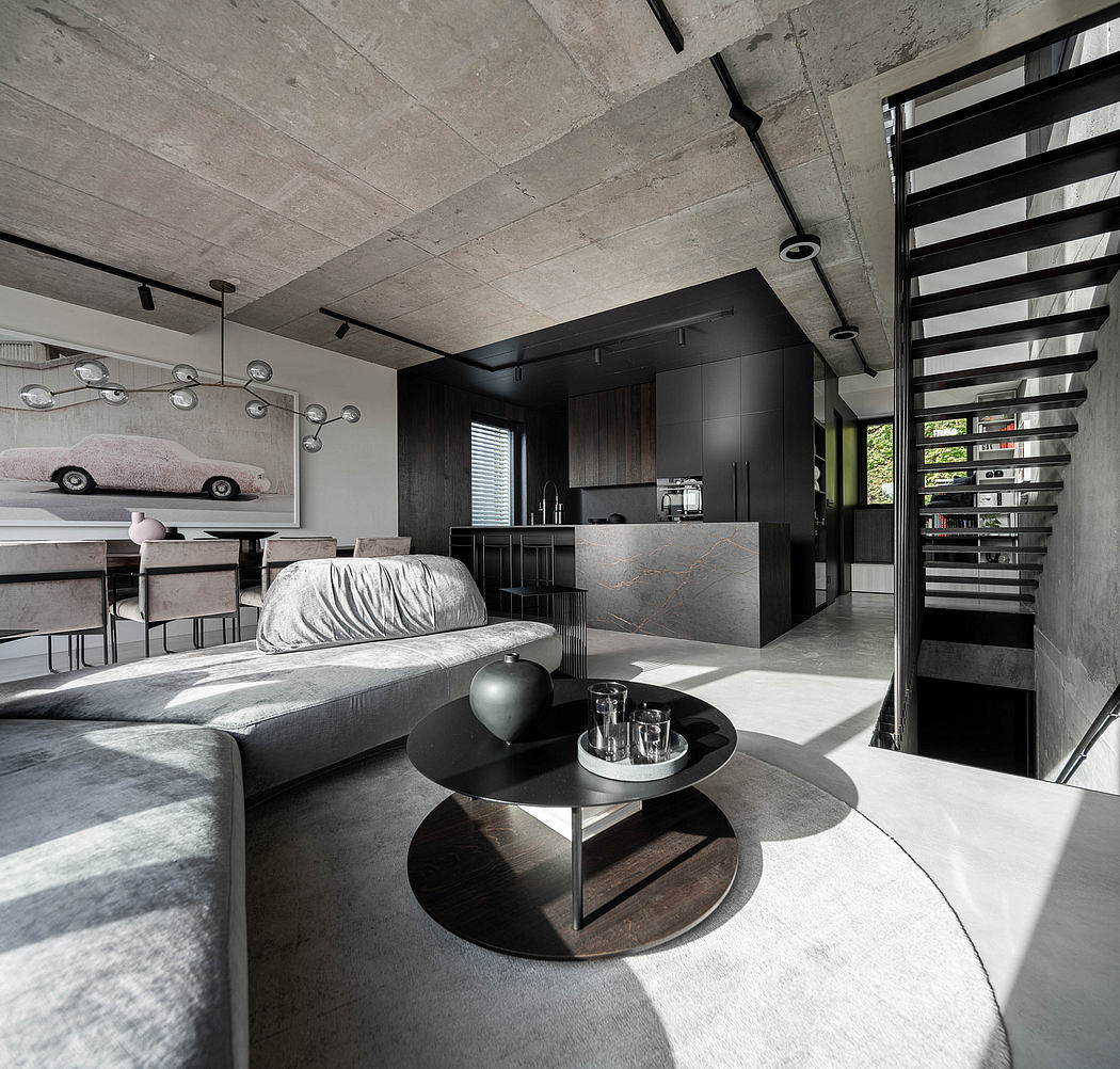 Contemporary living room with sleek furniture and a concrete ceiling.