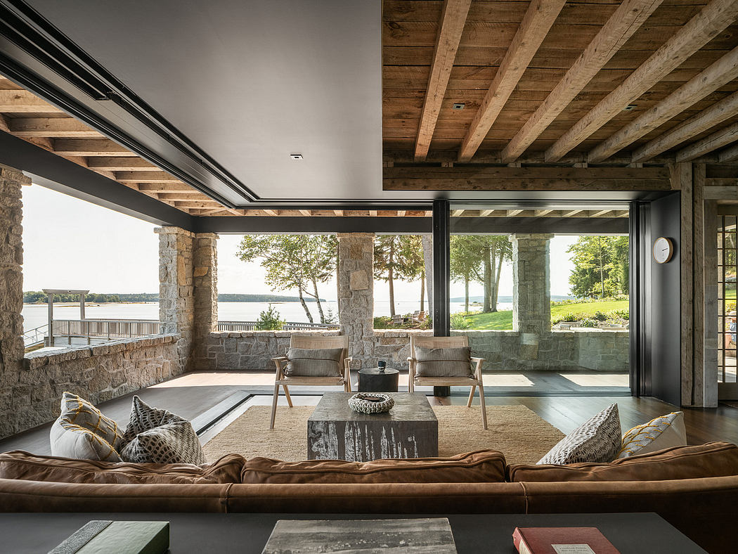 Contemporary living space with exposed beams and waterfront view.