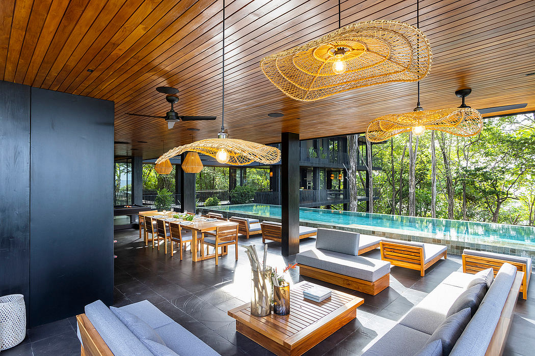 Modern room with wicker pendant lights, wooden ceiling, and pool view.