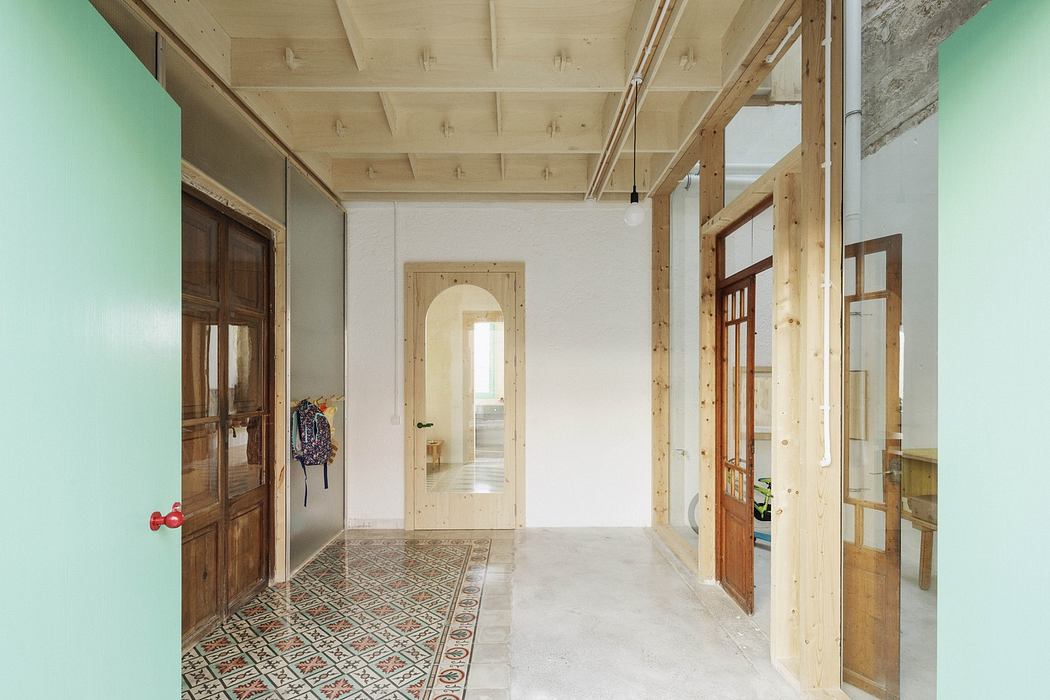 Modern hallway merging traditional and rustic elements, with patterned tiles and exposed beams.
