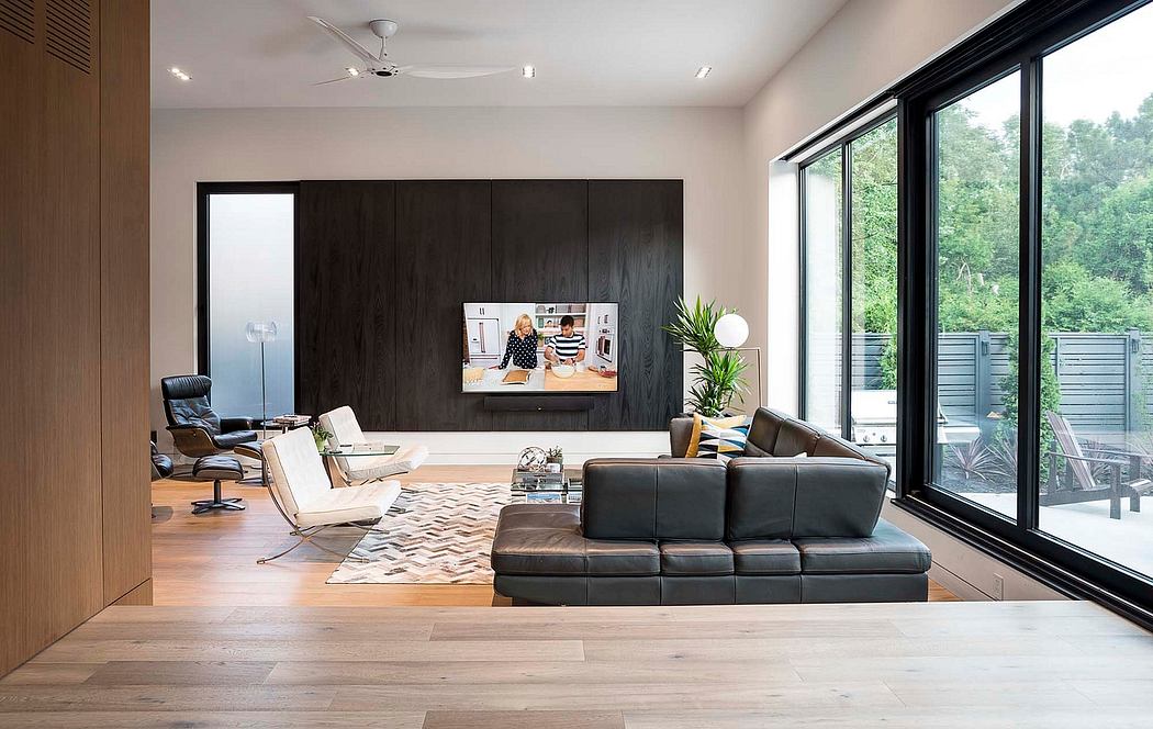 Modern living room with sleek furniture and large windows.