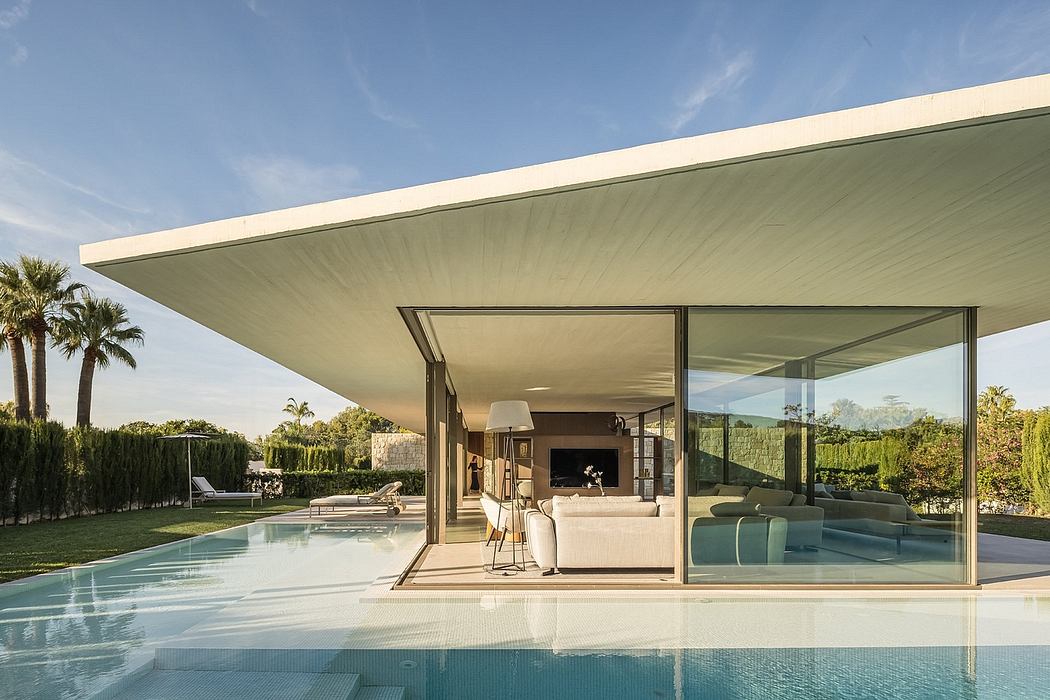 Sleek, minimalist house with expansive glass walls and an overhanging flat