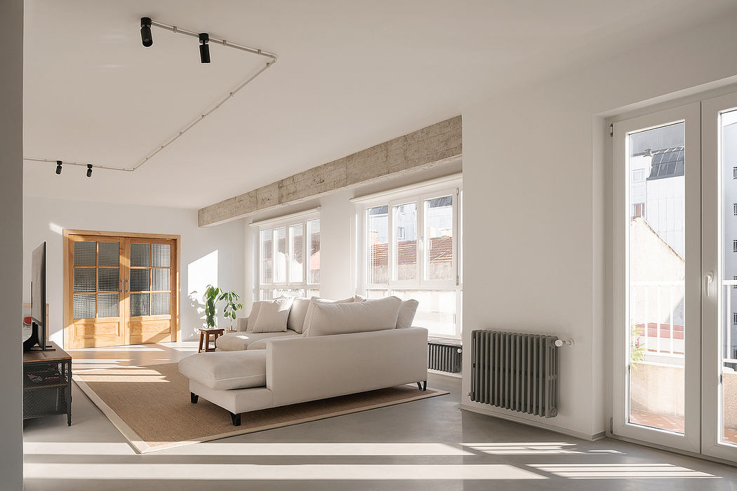 Bright modern living room with sofa and large windows.