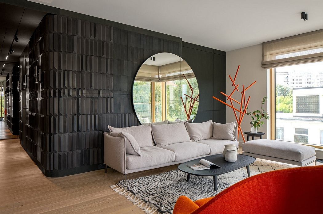 Contemporary living space with sculptural partition and circular mirror.