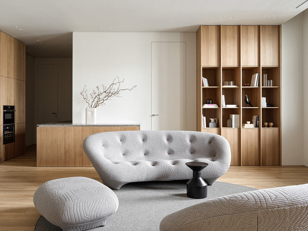 Modern living room with wooden bookshelf, tufted sofa, and minimalistic