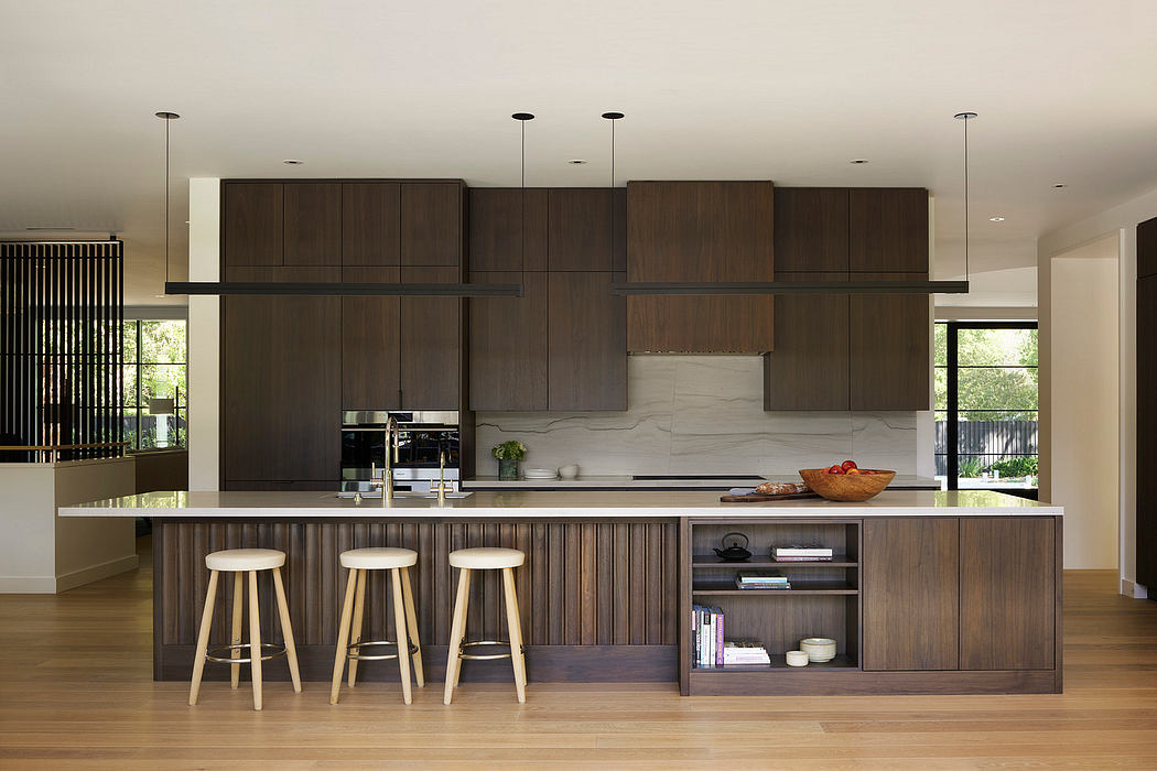 Contemporary kitchen with dark wood cabinetry and island with stools.