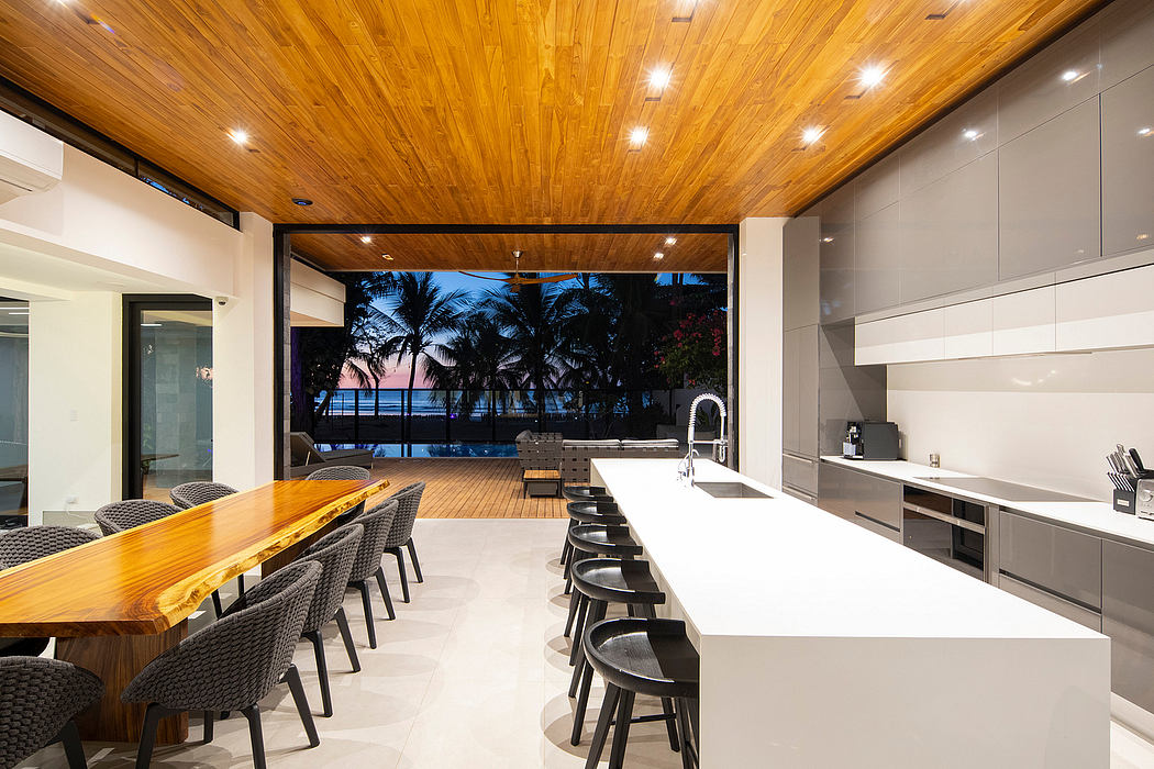 Elegant kitchen with rich wooden ceiling and ocean view.