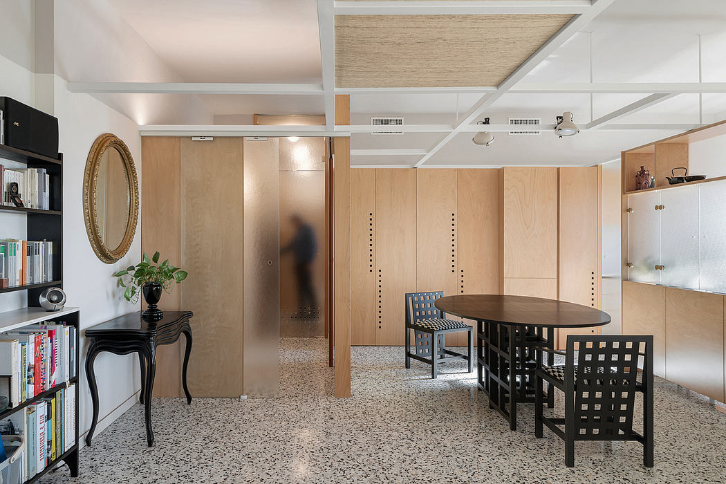 Modern room with wooden features, terrazzo flooring, and elegant furniture.