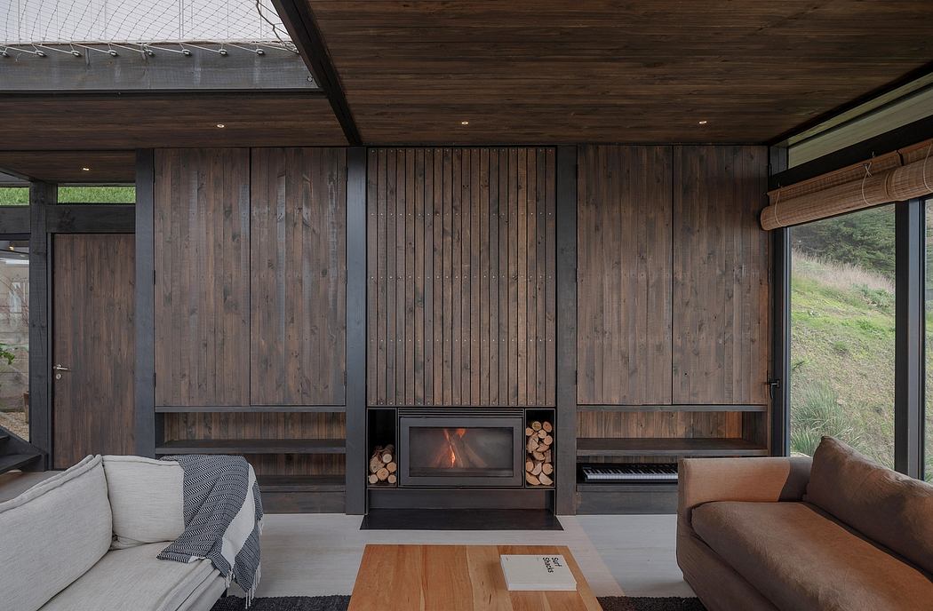 Contemporary living room with wooden walls and a minimalist fireplace.