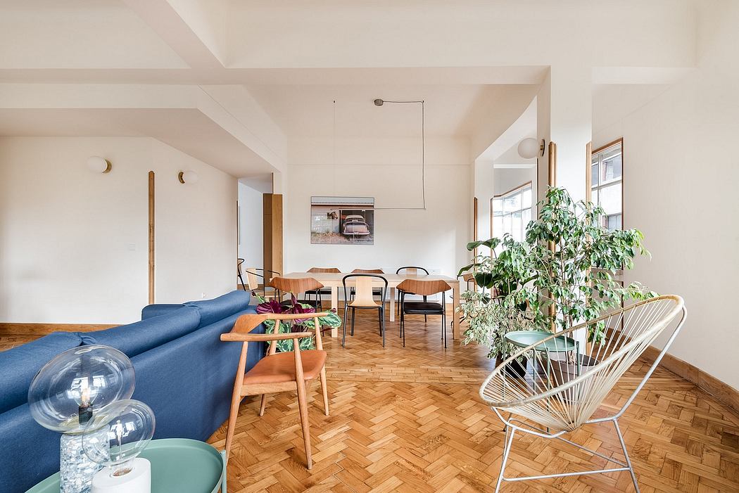 Bright, spacious living room with herringbone floors and minimalist decor.