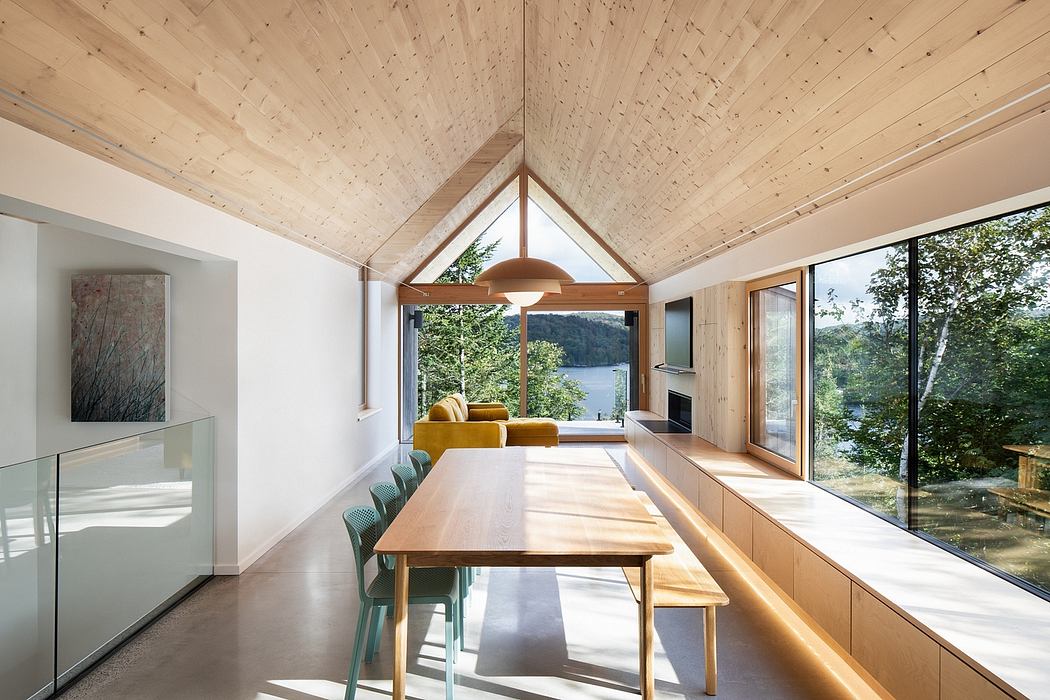 Modern dining room with wooden ceiling, large table, and nature view.
