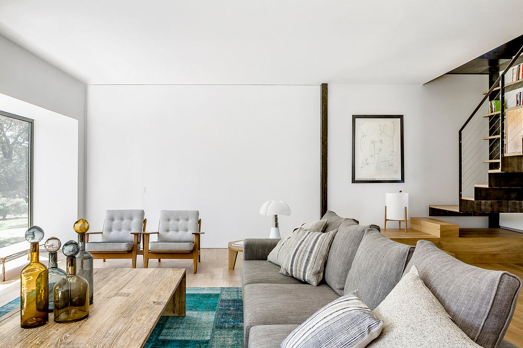 Modern living room with gray sofa, wooden table, and minimalist decor.