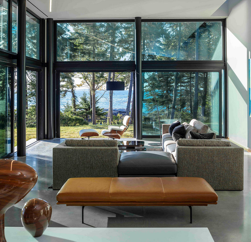 Contemporary living room with floor-to-ceiling windows, overlooking a lake.