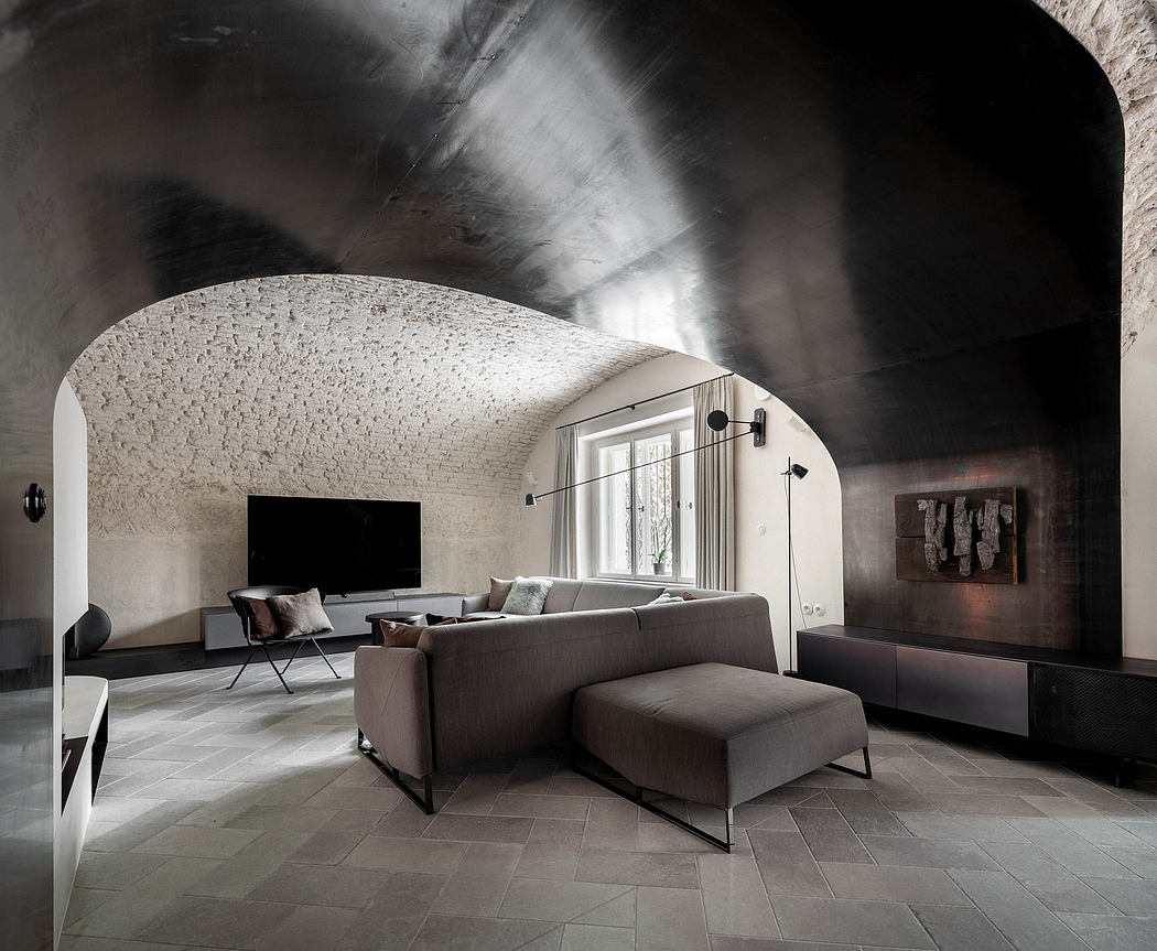 Modern living room with arched ceiling and minimalist furniture.