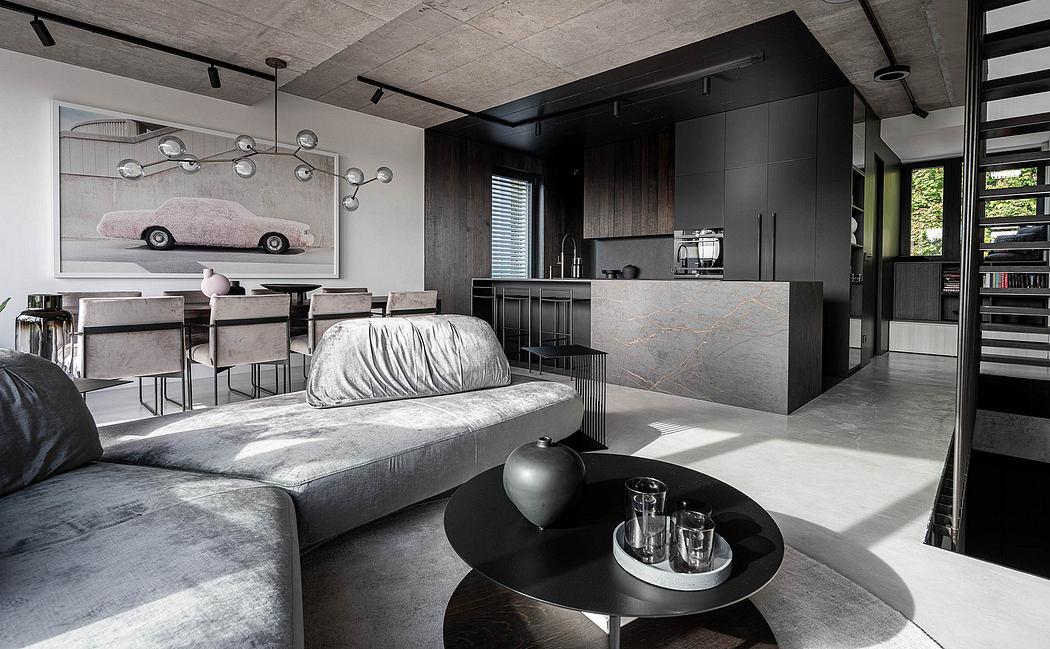 Modern living room with sleek furniture and kitchen area in the background.