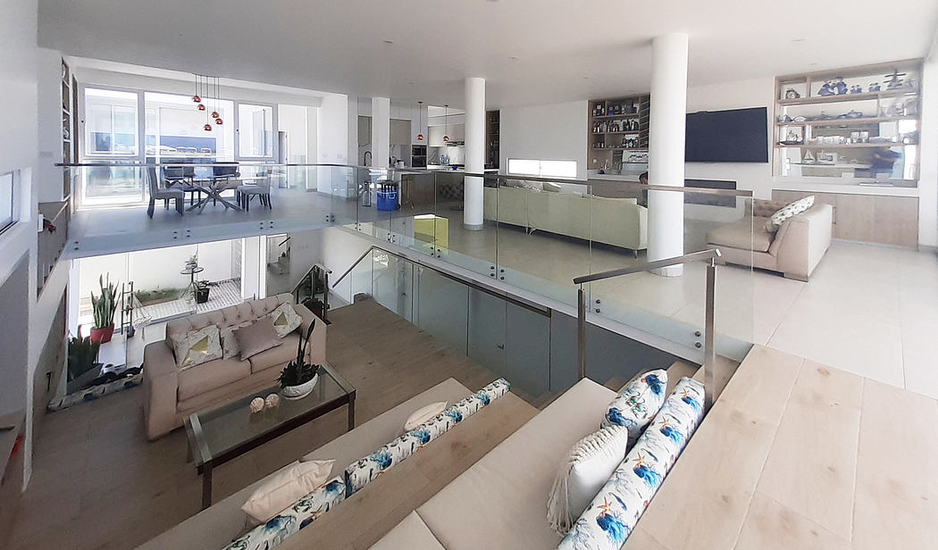 Modern open-plan living space with kitchen, dining, and living areas.