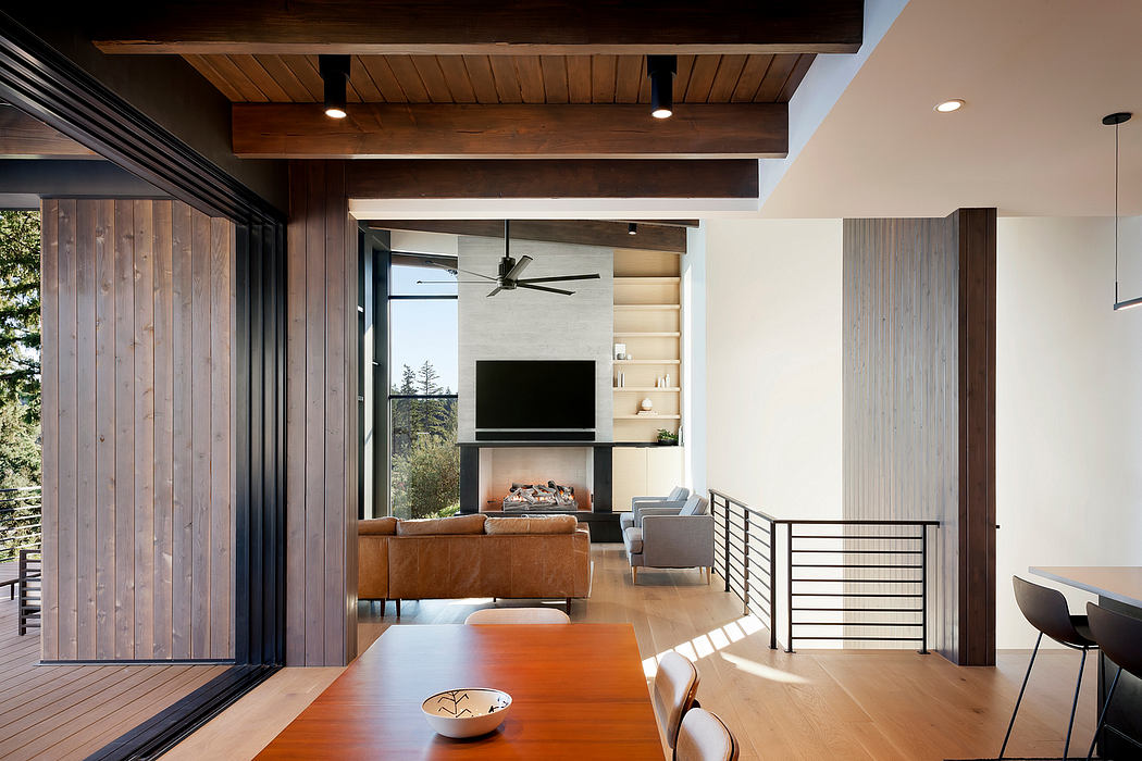 Contemporary interior with wooden ceilings, open-plan design, and large windows.