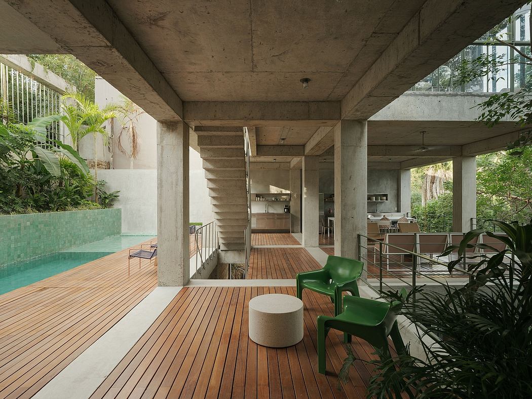 Modern open patio area with pool, concrete columns, wooden deck, and green chairs
