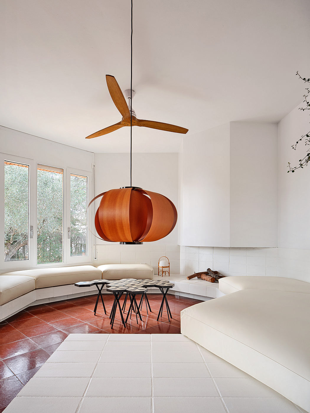 Bright modern room with a suspended fireplace and minimalistic furniture.