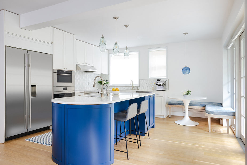 Bright kitchen with blue island and white cabinets