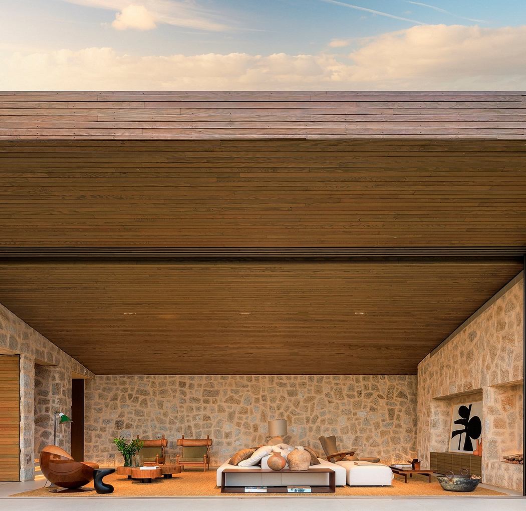 Contemporary living space with stone walls and wooden ceiling.