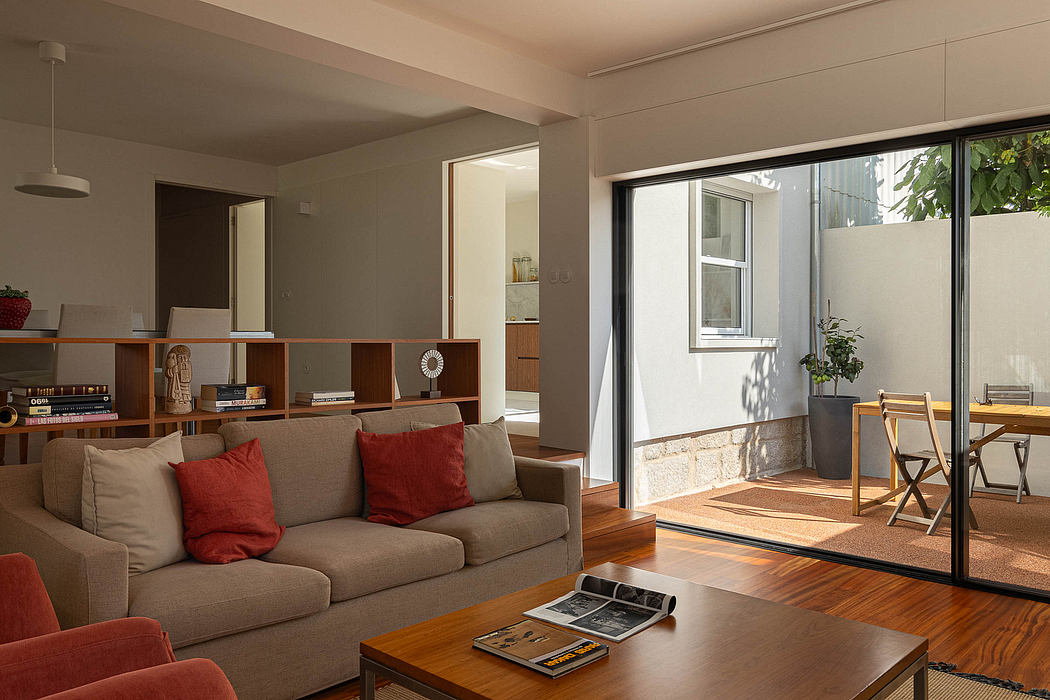 Contemporary living room with sliding glass door and outdoor seating.